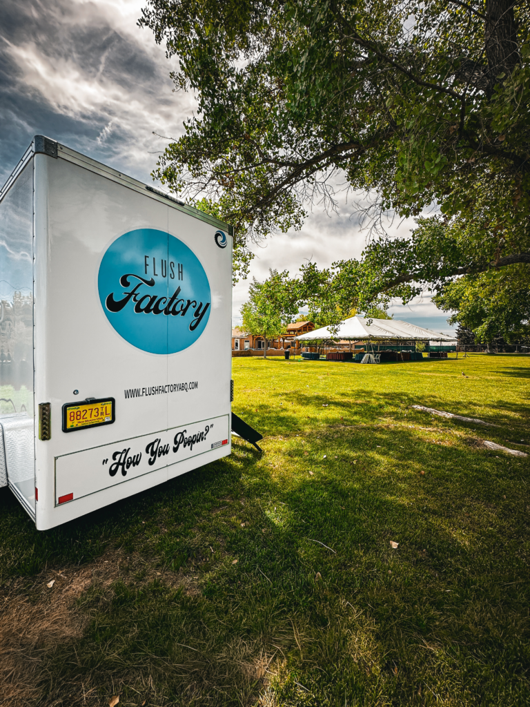 Flush Factory trailer at an outdoor tented event on the lawn