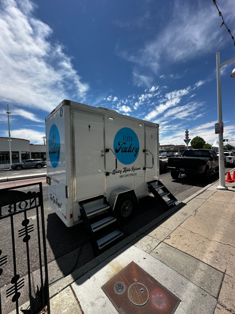 Restroom trailer set up curbside at an Albuquerque venue