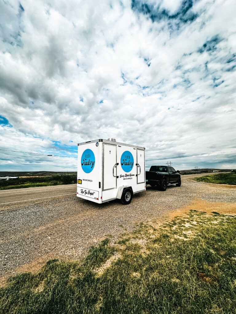 Flush Factory trailer at a countryside event under a dramatic sky