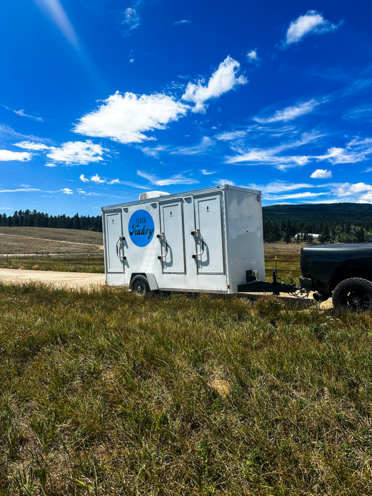 Luxury restroom trailer delivered to an open-field event site