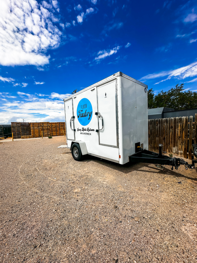 Flush Factory restroom trailer parked under blue New Mexico skies
