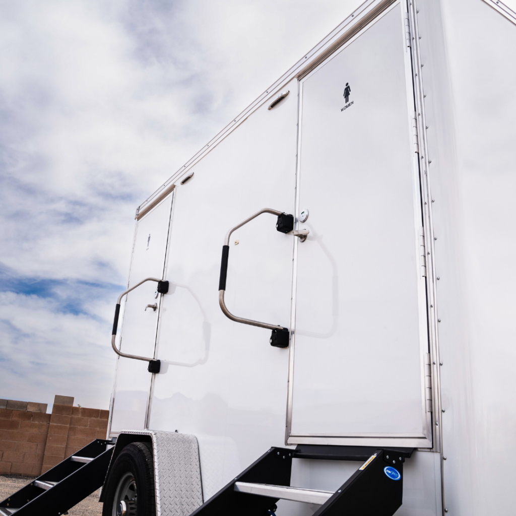 Side entrance and steps of a Flush Factory restroom trailer
